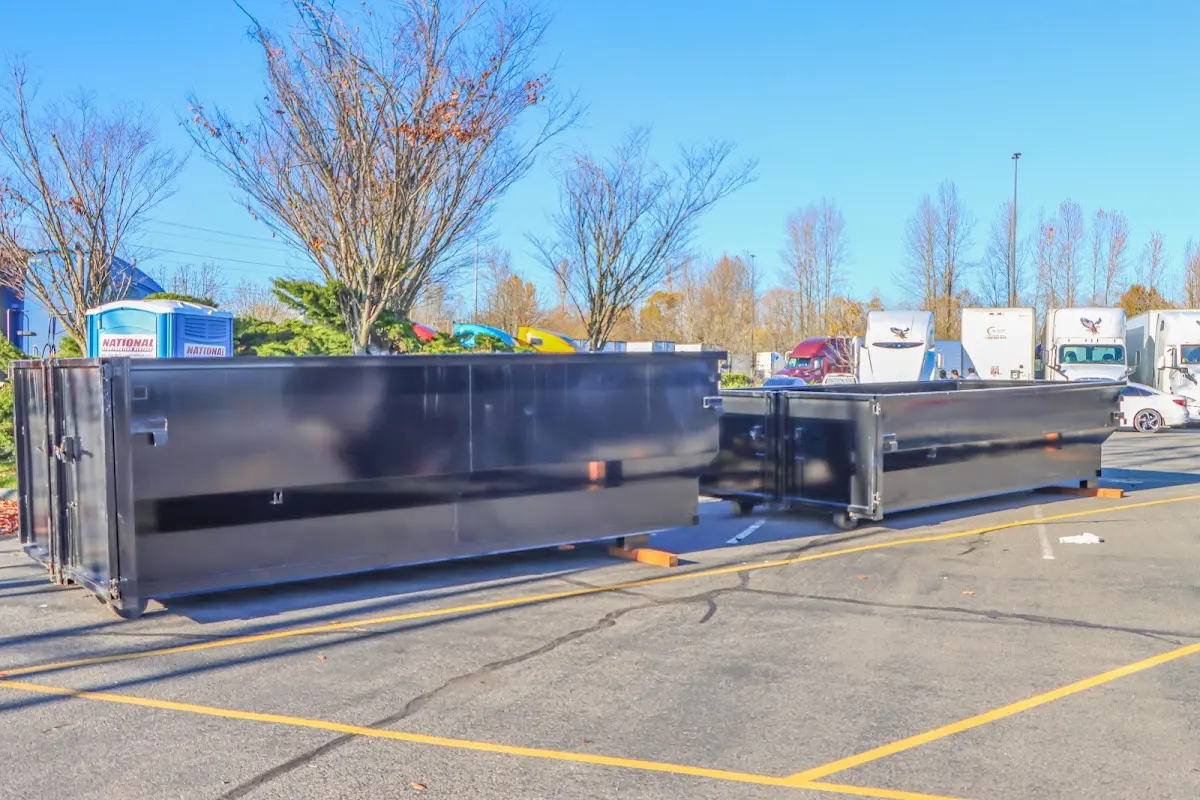 Professional dumpster rental service with roll-off container on residential driveway in Uhrichsville